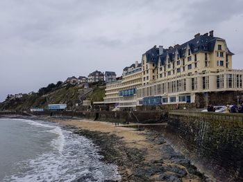 View of buildings against cloudy sky