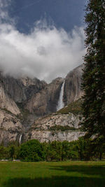 Scenic view of waterfall against sky