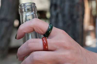 Cropped hand of person holding bottle