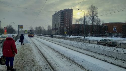 Rear view of snow covered railroad tracks in winter