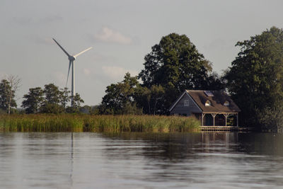 Built structure by lake against sky