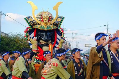 People in traditional clothing against sky