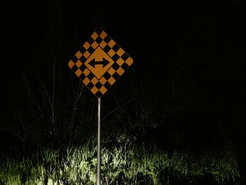 Close-up of yellow lights on field against black background