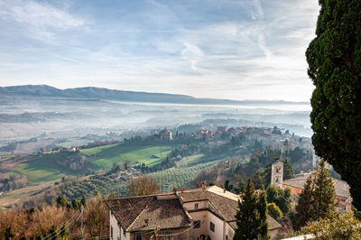 Panoramic view of buildings and mountains against sky
