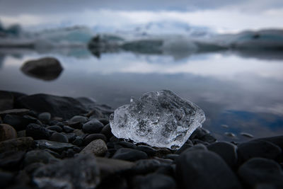 Rocks on beach against sky