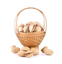 Close-up of fruits in basket against white background