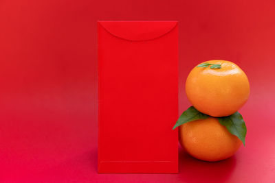 High angle view of oranges against red background