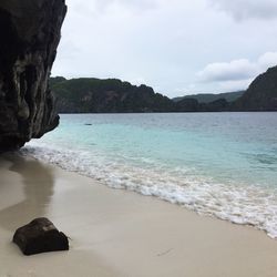 Scenic view of sea against cloudy sky