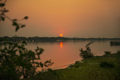 Scenic view of lake against sky during sunset