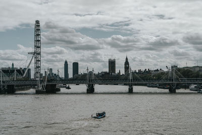 View of bridge over river against cloudy sky