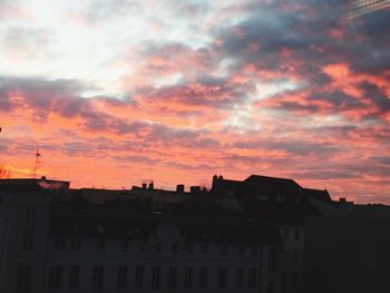 Silhouette city against sky during sunset