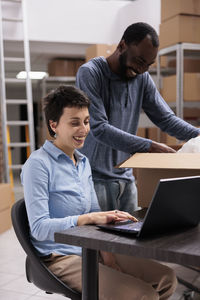 Businesswoman using laptop while sitting at office