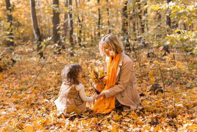 Full length of women in forest during autumn