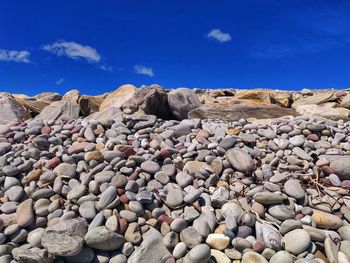 Stones on rock against sky