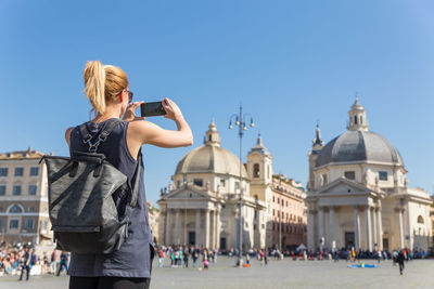 People photographing against sky