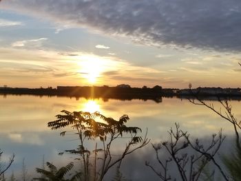 Scenic view of lake against sky during sunset