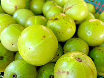 An indian gooseberry in the basket on a wooden floor