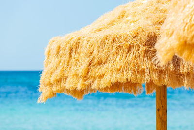 Beach beautiful thatched umbrellas and turquoise sea.