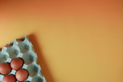 Close-up of eggs against orange background