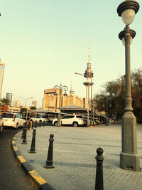 Street lights in city against clear sky
