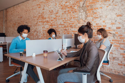 Group of people using laptop on table