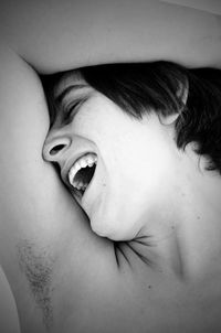 Cropped image of shirtless woman with hand on head