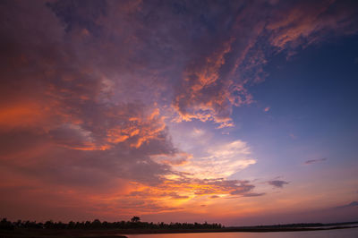 Low angle view of silhouette field against sky during sunset