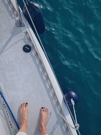 Low section of person in swimming pool at sea