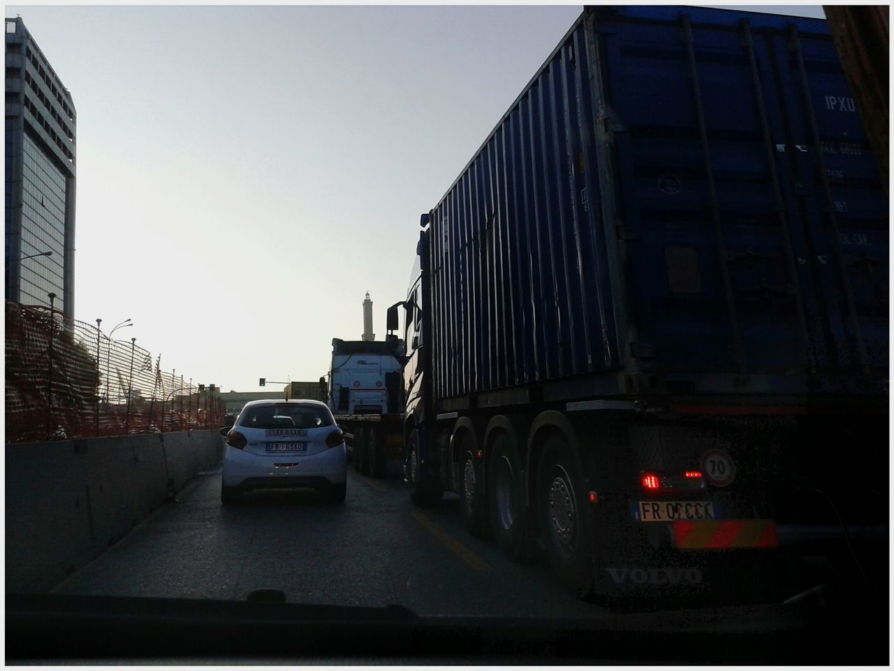 CARS ON ROAD ALONG BUILDINGS