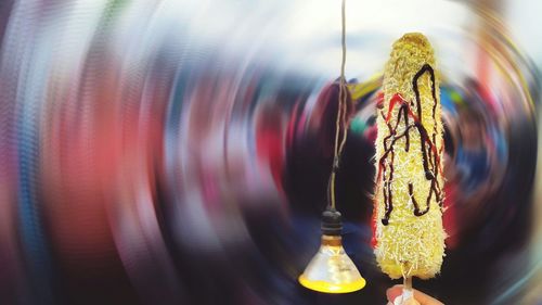 Close-up of light painting hanging on metal