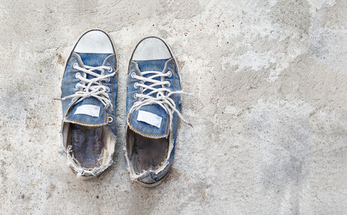 High angle view of shoes on concrete floor