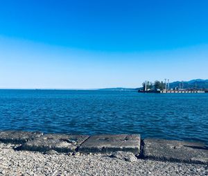 Scenic view of sea against clear blue sky