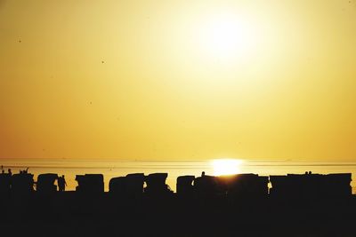 Scenic view of silhouette landscape against orange sky