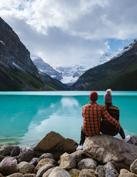 Rear view of man looking at lake