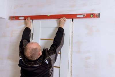 Low section of woman exercising against wall