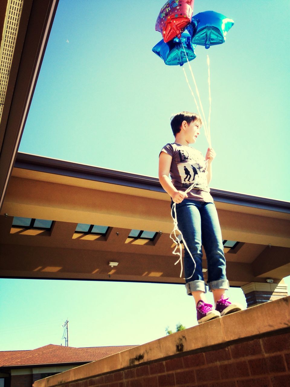 blue, full length, built structure, casual clothing, architecture, building exterior, lifestyles, standing, low angle view, leisure activity, clear sky, childhood, person, boys, railing, day, sunlight, front view