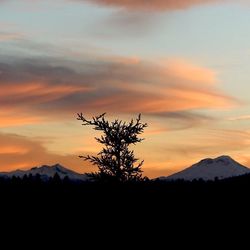 Scenic view of mountains against sky at sunset