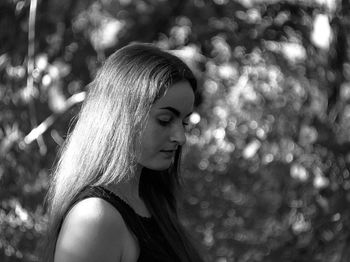 Portrait of young woman looking away outdoors