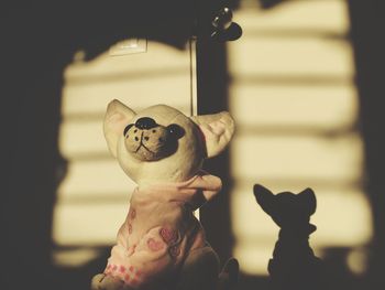 Close-up of stuffed toy against wall at home