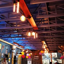 Low angle view of illuminated lanterns hanging on ceiling