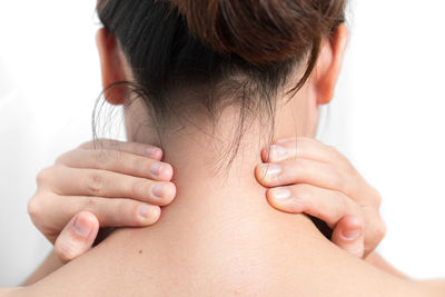 Rear view of woman with hands on neck