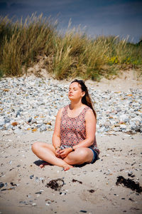 Portrait of woman sitting on beach