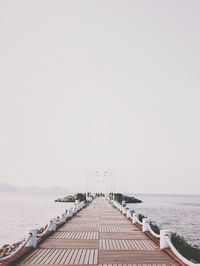 Pier over sea against clear sky