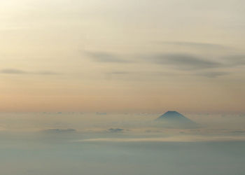 Idyllic shot of mt fuji in foggy weather against sky