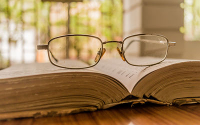 Close-up of eyeglasses on book