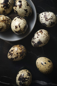 Quail eggs on a marble table.