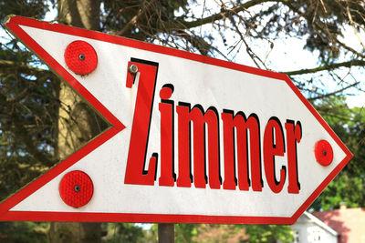 Low angle view of road sign against sky