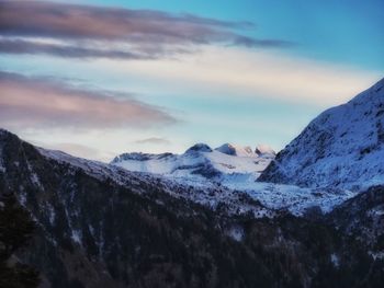 Scenic view of snowcapped mountains against sky during sunset