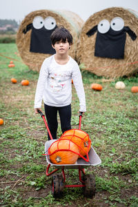 Portrait of young woman sitting on grassy field