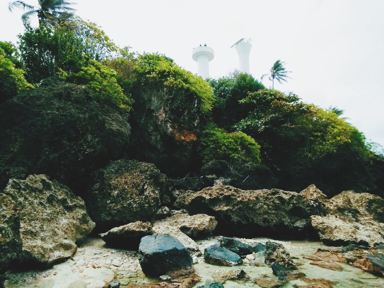 LOW ANGLE VIEW OF ROCKS IN WATER AGAINST SKY